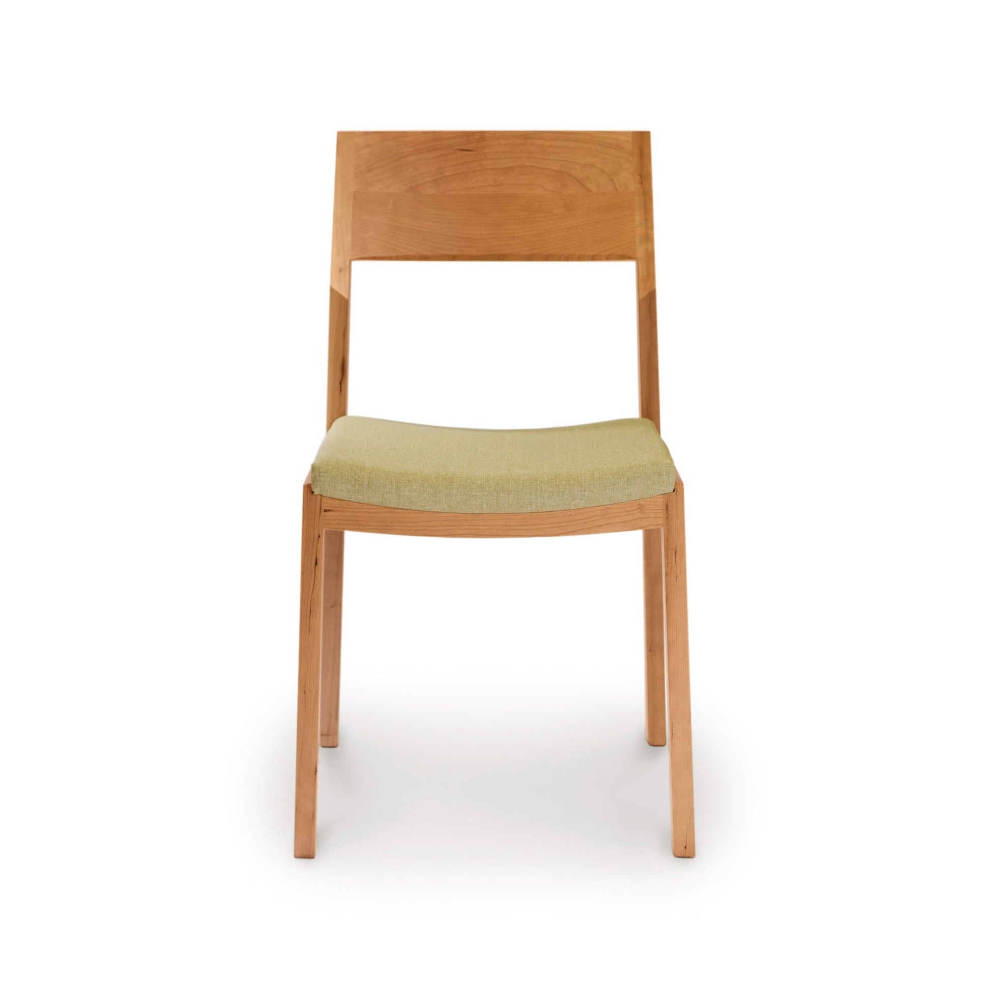 An Iso Chair - Priority Ship by Copeland Furniture, featuring a cherry wood frame and a green upholstered seat, made using sustainably sourced hardwoods.