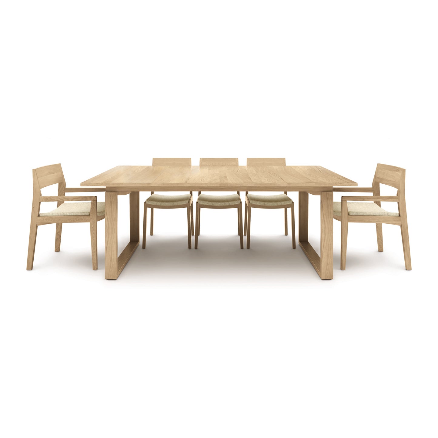 A solid oak Copeland Furniture Iso Extension Dining Table with six matching chairs on a white background.