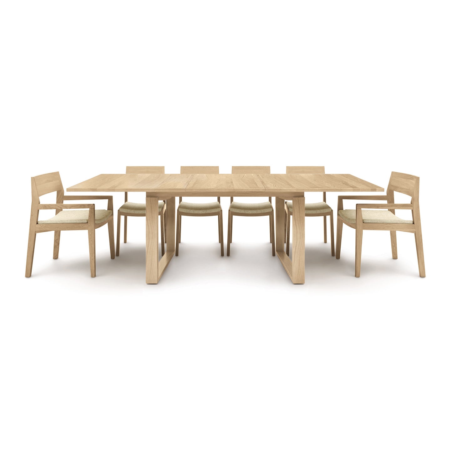 A solid oak Copeland Furniture Iso Oak Extension Dining Table with six matching chairs arranged neatly around it on a plain white background.