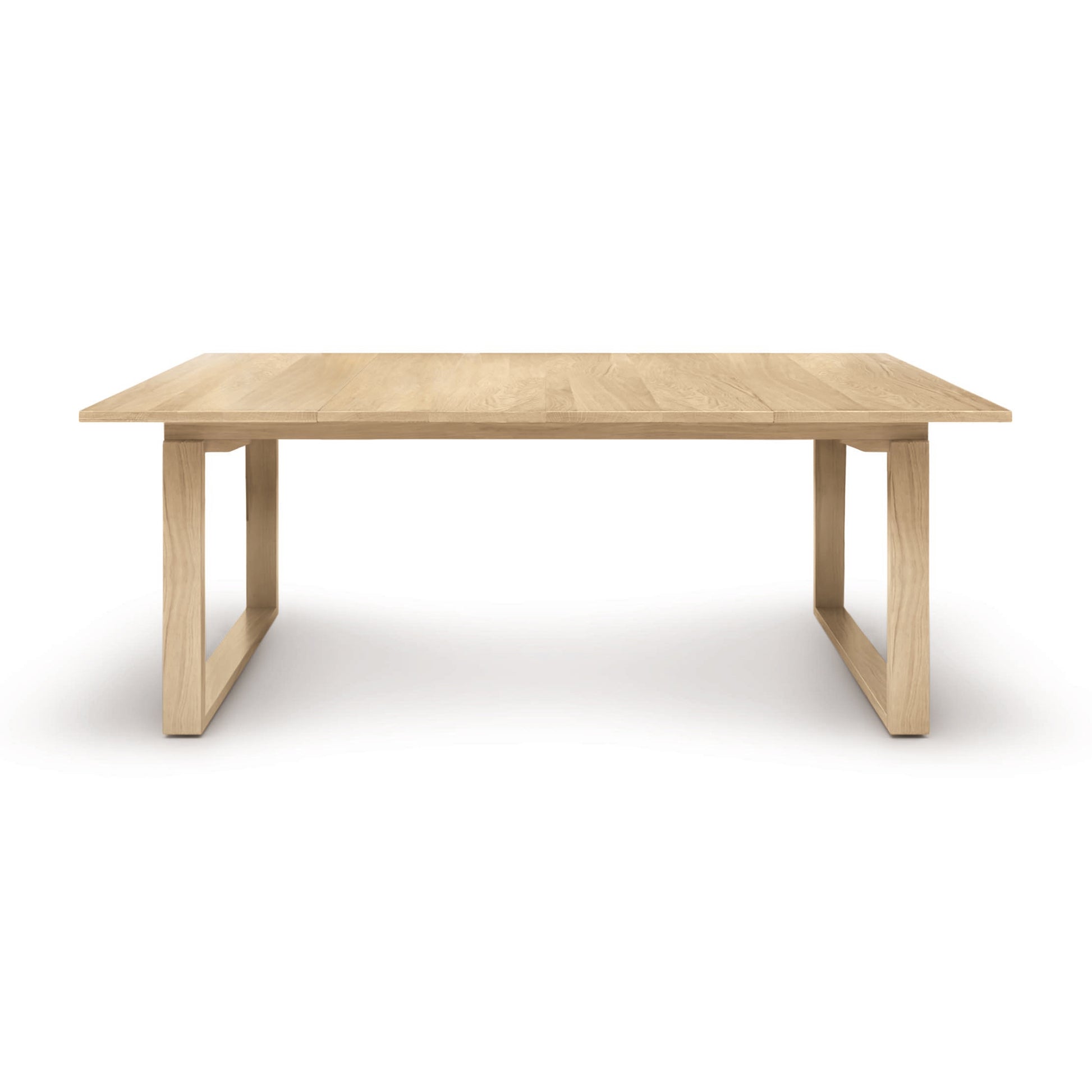A simple Copeland Furniture Iso Oak Extension Dining Table with a rectangular top and sturdy legs, placed against a white background.