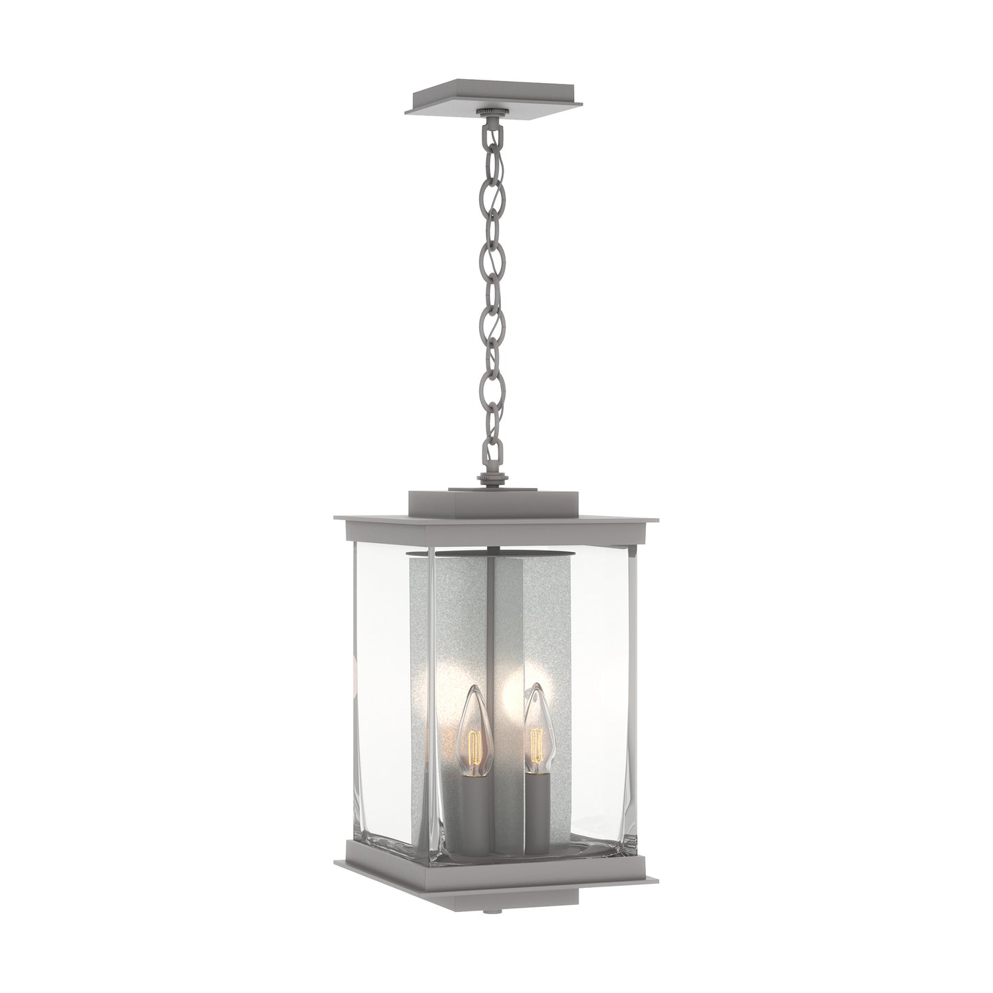 Kingston Outdoor Large Lantern by Hubbardton Forge with clear glass panels, metal frame, and two candle bulbs suspended inside the lantern.
