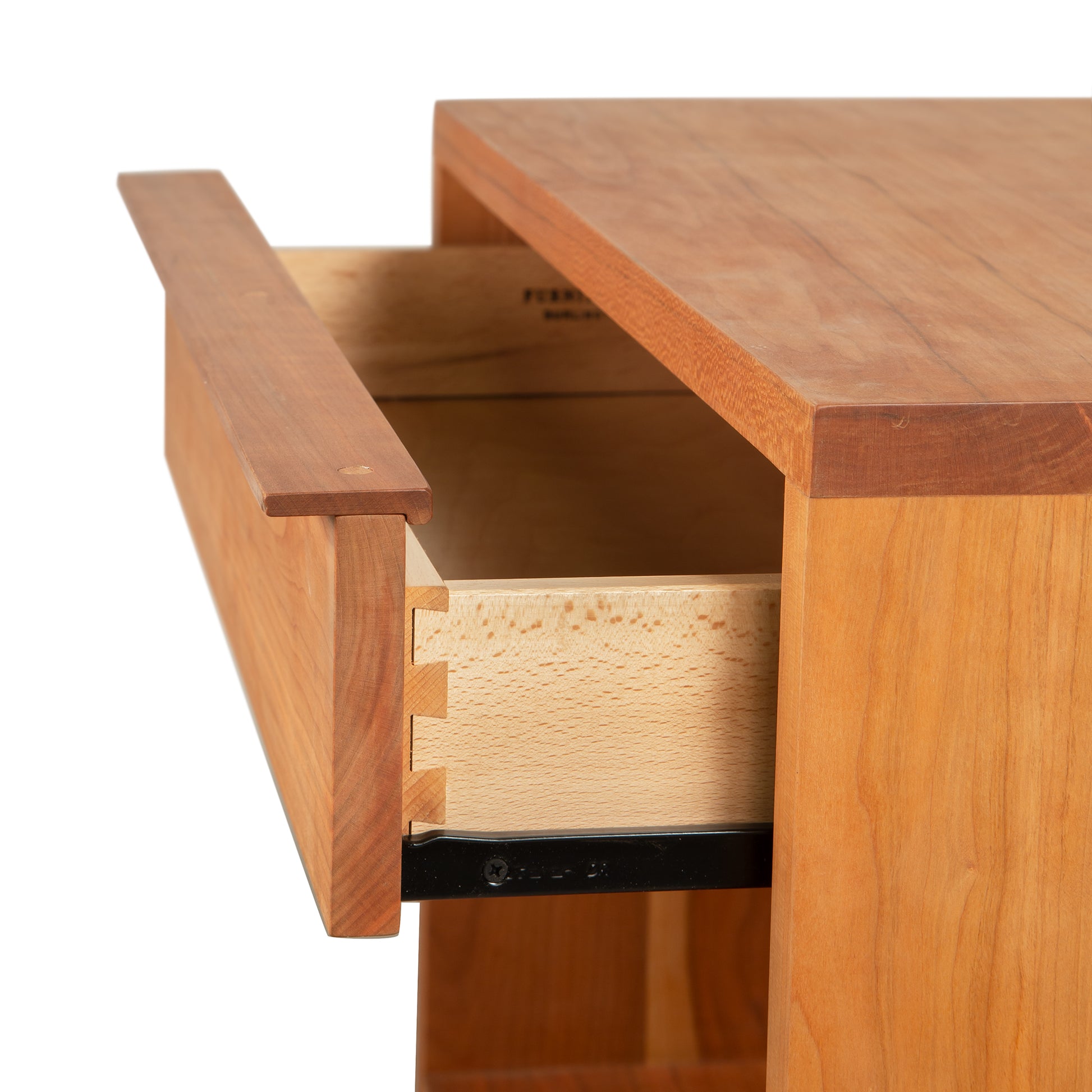 Modern wooden desk featuring exposed dovetail joints on an open drawer, similar to Vermont Furniture Designs' Kipling 1-Drawer Nightstand.