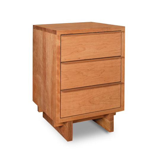 Vermont Furniture Designs 3-Drawer Nightstand isolated on a white background, featuring a modern design in natural cherry.