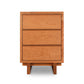 A modern design Vermont Furniture Designs Kipling 3-Drawer Nightstand in natural cherry against a white background.