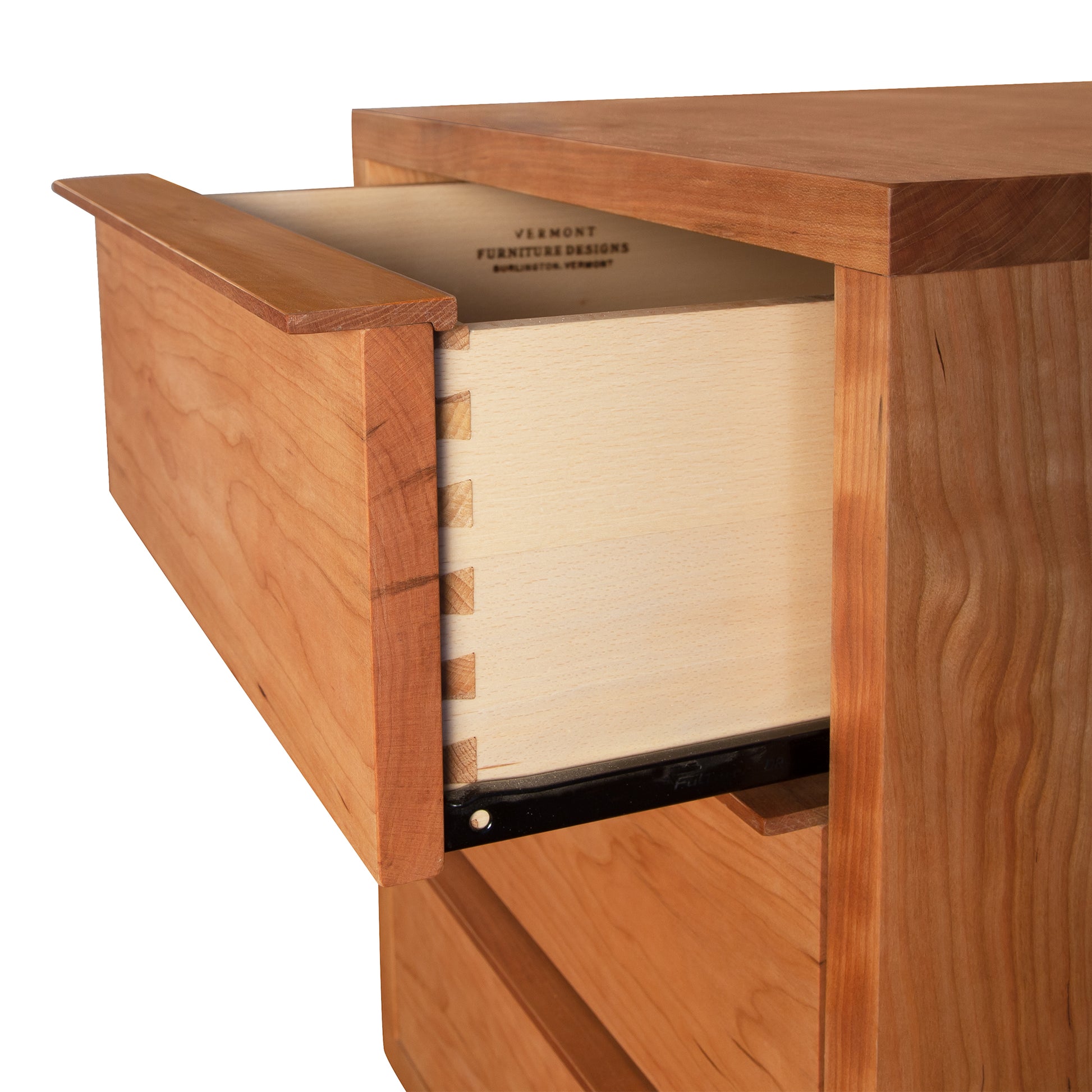 An open wooden drawer revealing its dovetail joint construction and the label of the maker "Vermont Furniture Designs" features a modern design, showcasing the Kipling 3-Drawer Nightstand.