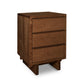 A natural cherry Vermont Furniture Designs 3-Drawer Nightstand isolated on a white background.