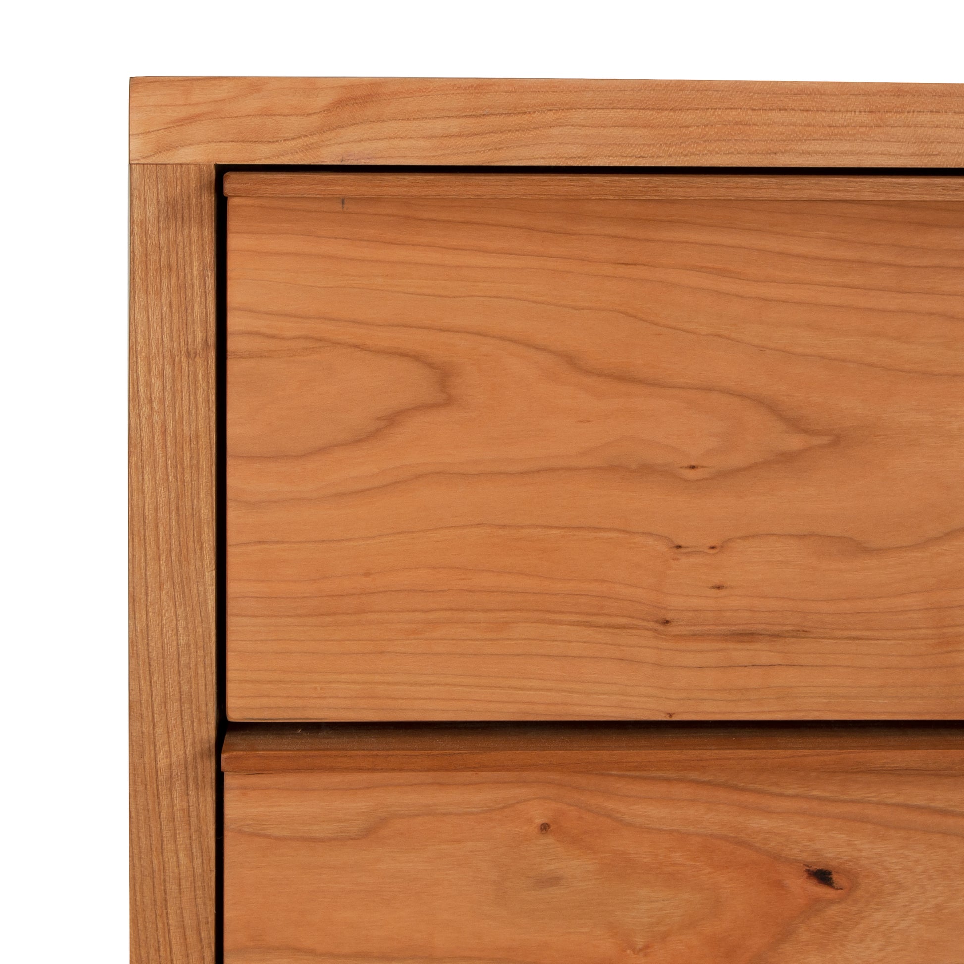 Close-up view of a wooden drawer from the Vermont Furniture Designs Kipling 5-Drawer Wide Chest, showing the grain patterns of the wood and the joint details indicative of Vermont craftsmanship.