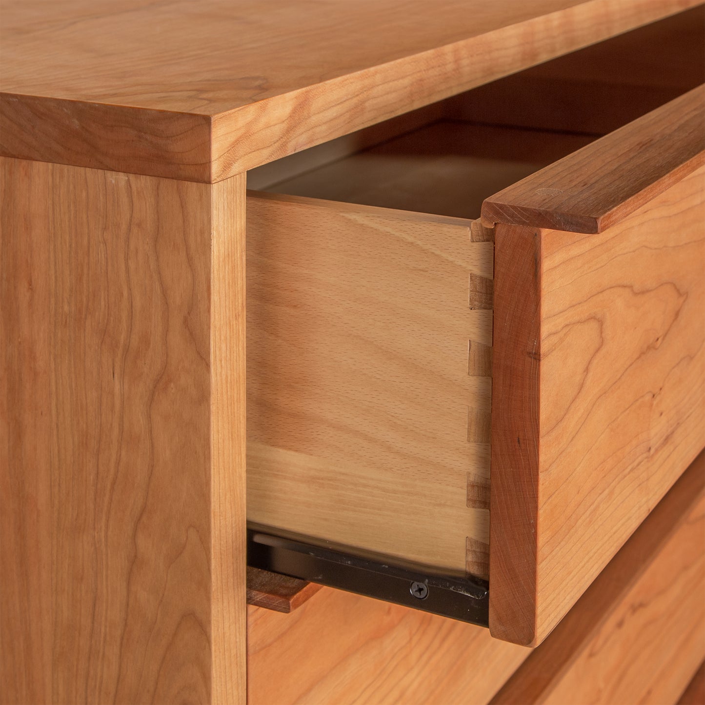 Close-up of dovetail joints and metal runners in the Kipling 8-Drawer Dresser by Vermont Furniture Designs, featuring a natural finish.