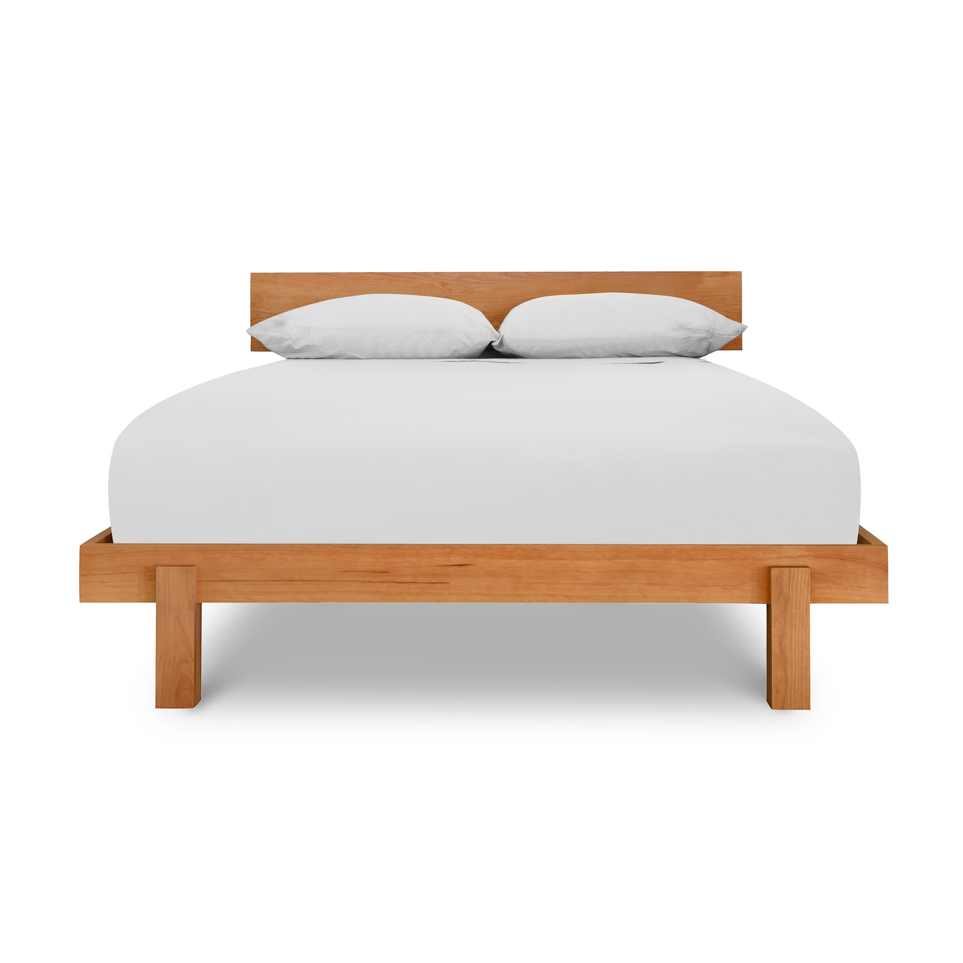 Solid wood Kipling Bed by Vermont Furniture Designs with white sheets and pillows on a sturdy mattress.