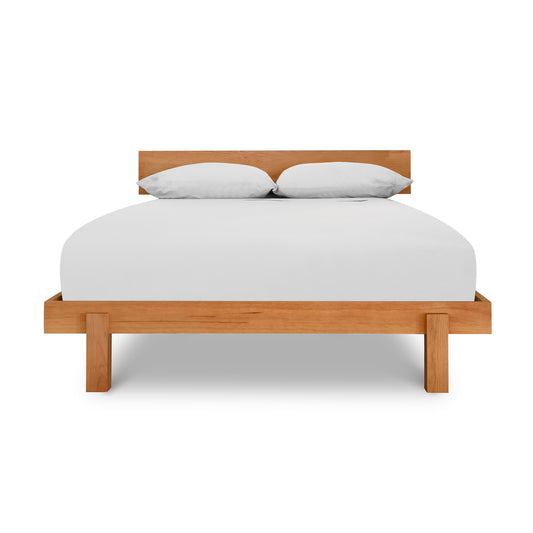 Solid wood Kipling Bed by Vermont Furniture Designs with white sheets and pillows on a sturdy mattress.