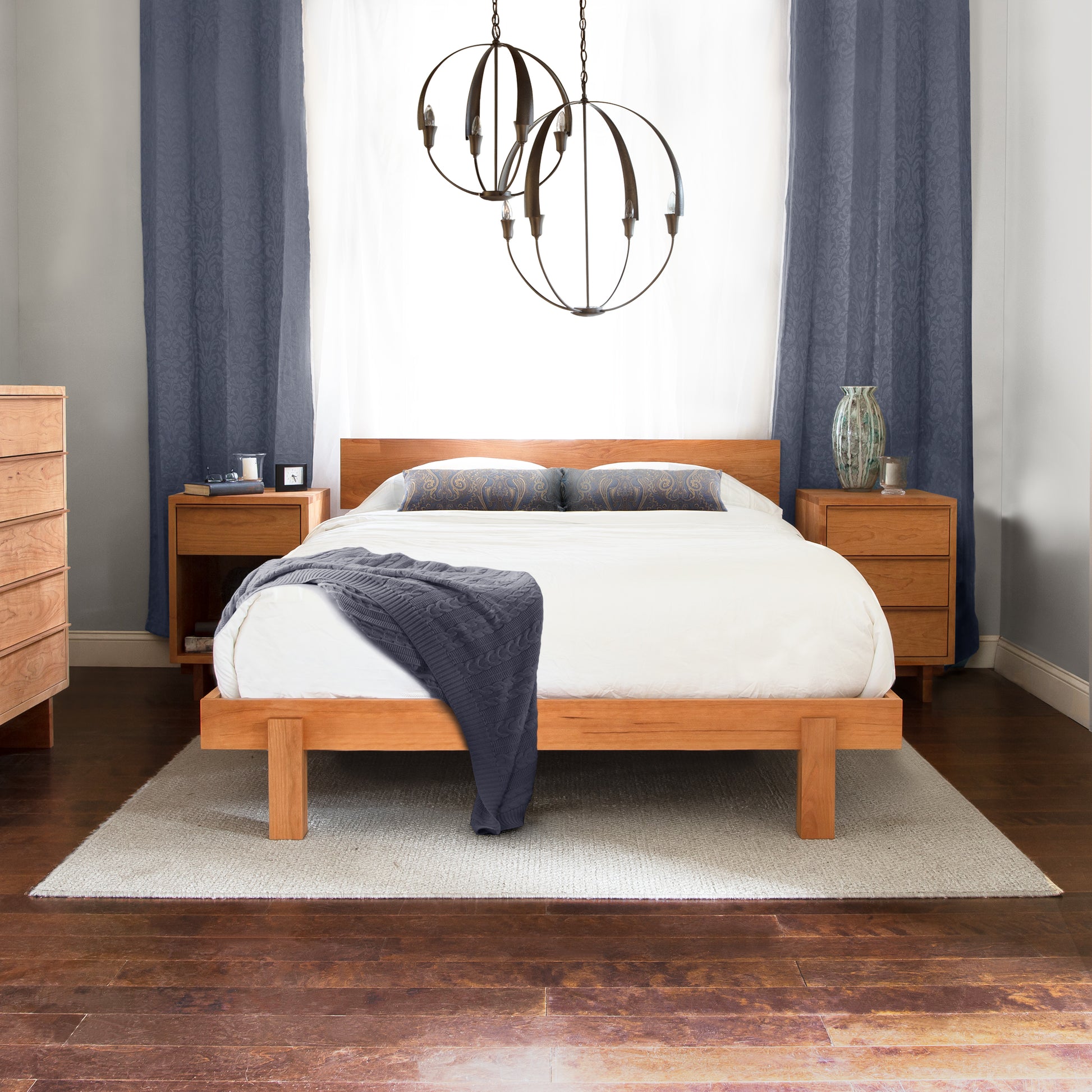 Vermont Furniture Designs Kipling Bed with white bedding and gray throw, complemented by wooden nightstands.