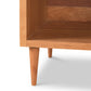 Vermont Furniture Designs Larssen 1-Drawer Enclosed Shelf Nightstand, with tapered legs, viewed from a lower angle focusing on its corner and isolated on a white background.