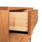 An open drawer revealing dovetail joint construction in a Larssen 6-Drawer Dresser made of mid-century modern design solid wood, by Vermont Furniture Designs.