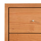 Close-up of a solid wood Vermont Furniture Designs Larssen 6-Drawer Dresser drawer with a single metal knob.