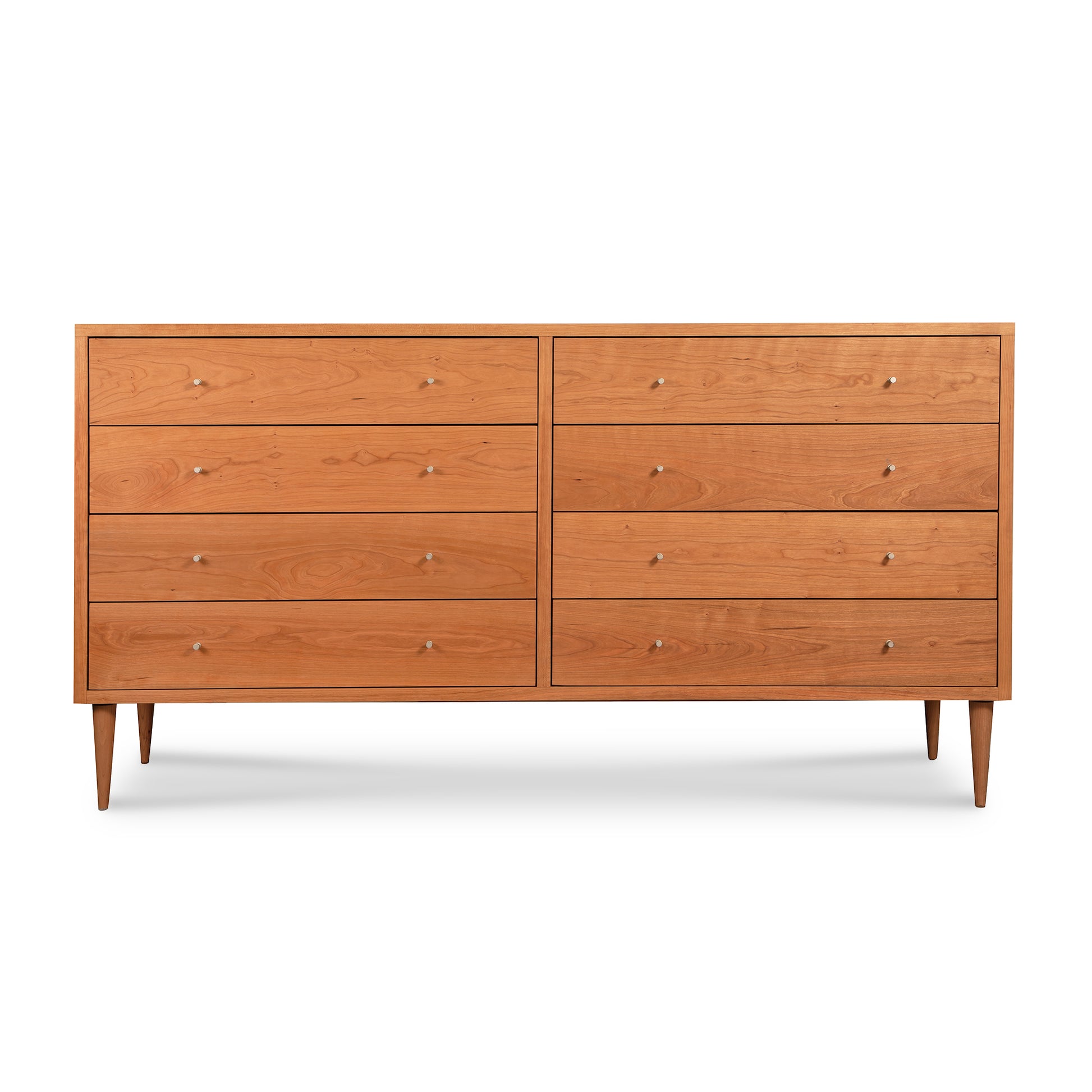 A Vermont Furniture Designs Larssen 8-Drawer Dresser, with a solid wood mid-century modern design, standing on four angled legs against a white background.