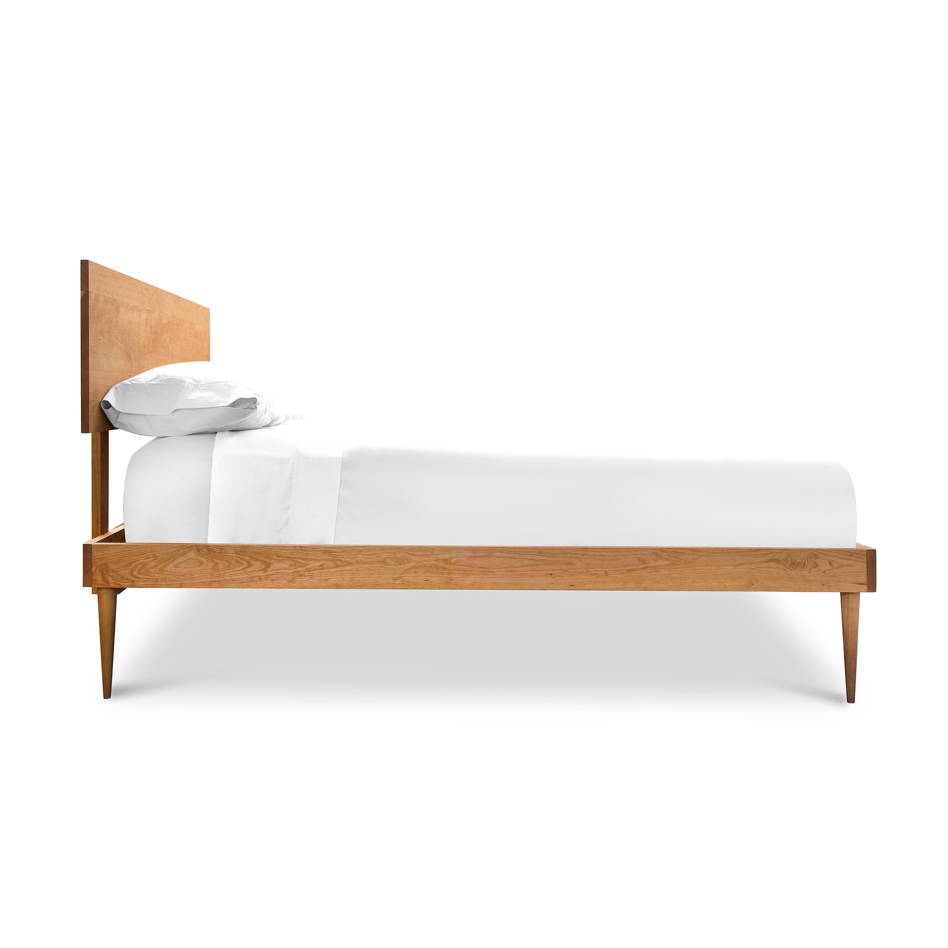 Larssen Bed from Vermont Furniture Designs, featuring a mid-century modern style with a high headboard and elegantly tapered wooden legs.