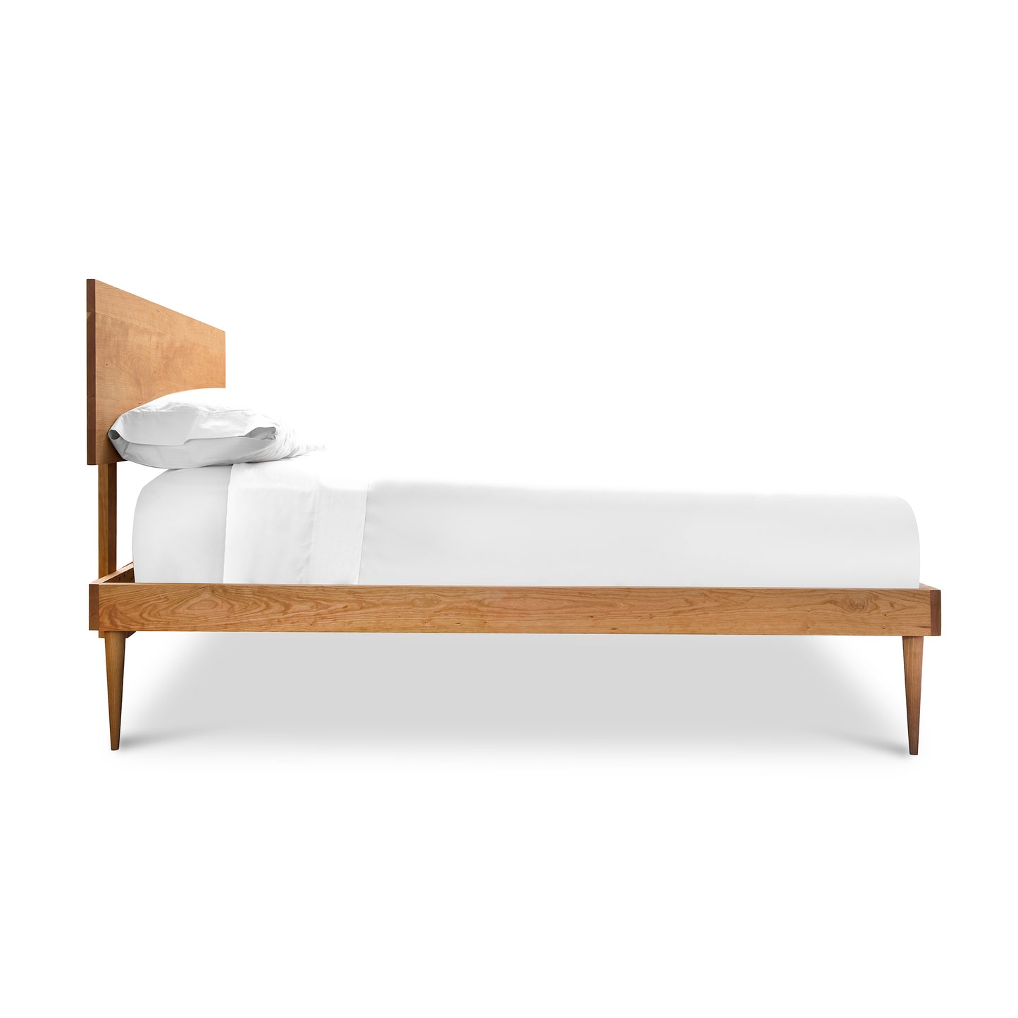 A Vermont Furniture Designs Larssen Bed with a white mattress and pillows, isolated on a white background.