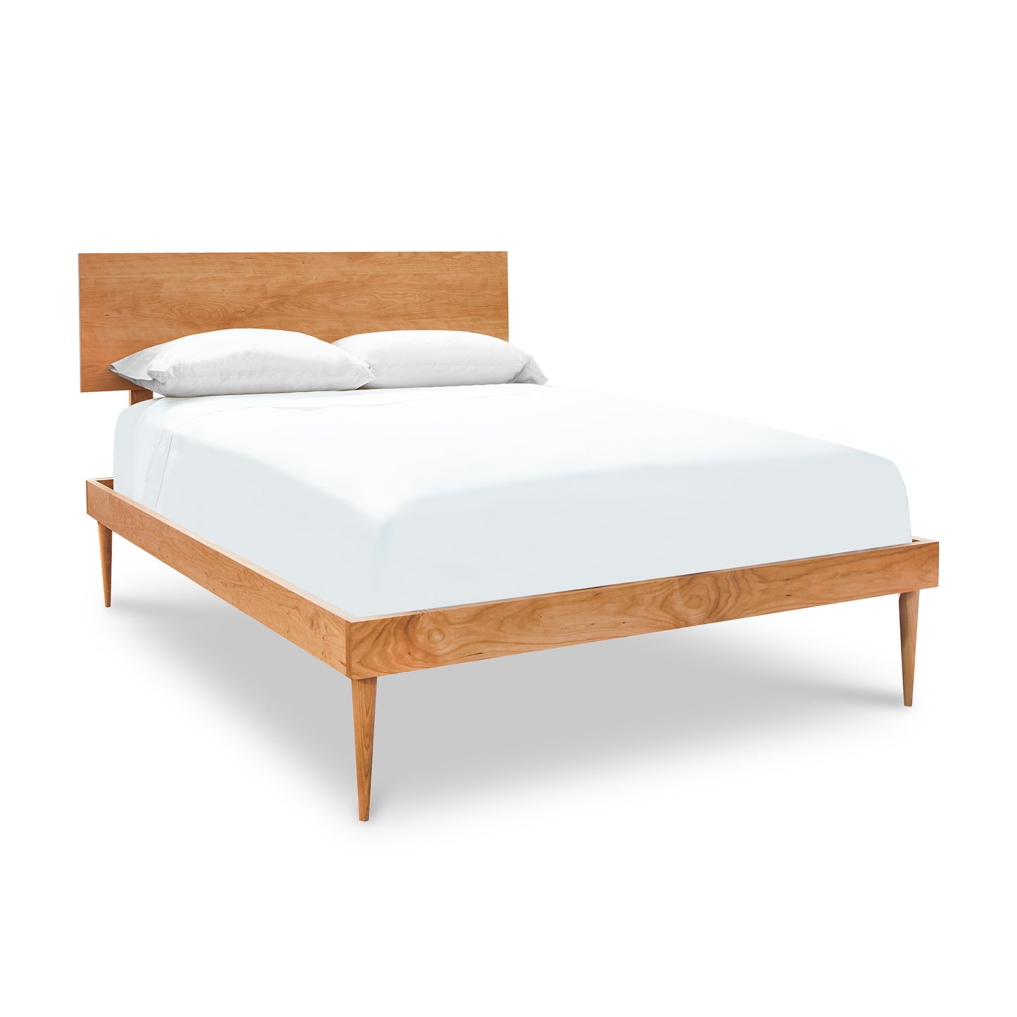 A Larssen Bed by Vermont Furniture Designs, featuring a Mid-century modern design wooden bed frame with a headboard, fitted with white bedding and two pillows, isolated on a white background.