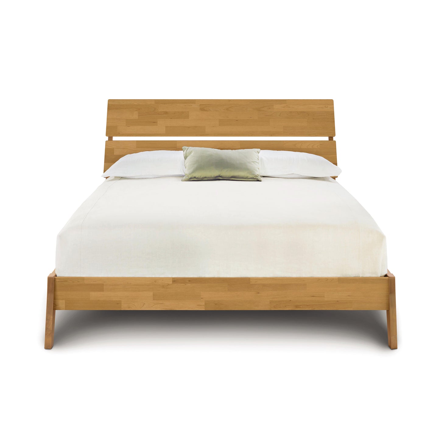 Modern and sustainable Linn Platform Bed by Copeland Furniture with white bedding and a green cushion.
