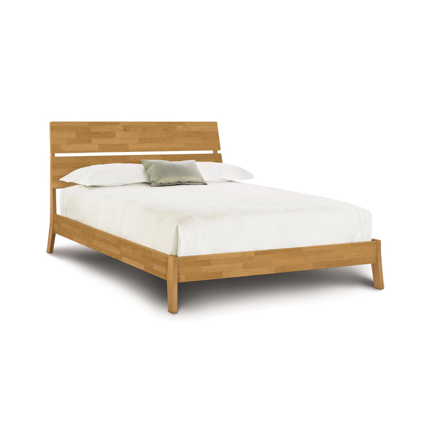 Copeland Linn Platform Bed in cherry wood, queen size, American made, showcasing sleek lines and craftsmanship. Bedding is white with two pillows and a cushion.