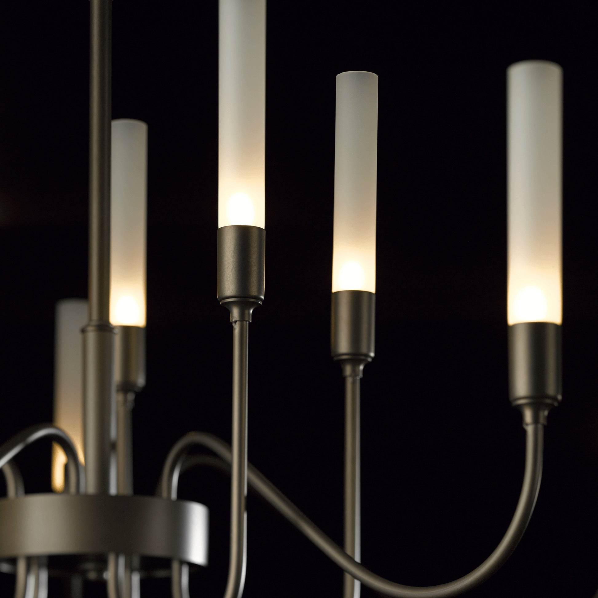 Hubbardton Forge Lisse 10-Arm Chandelier with frosted glass shades, metal arms, and glowing bulbs.