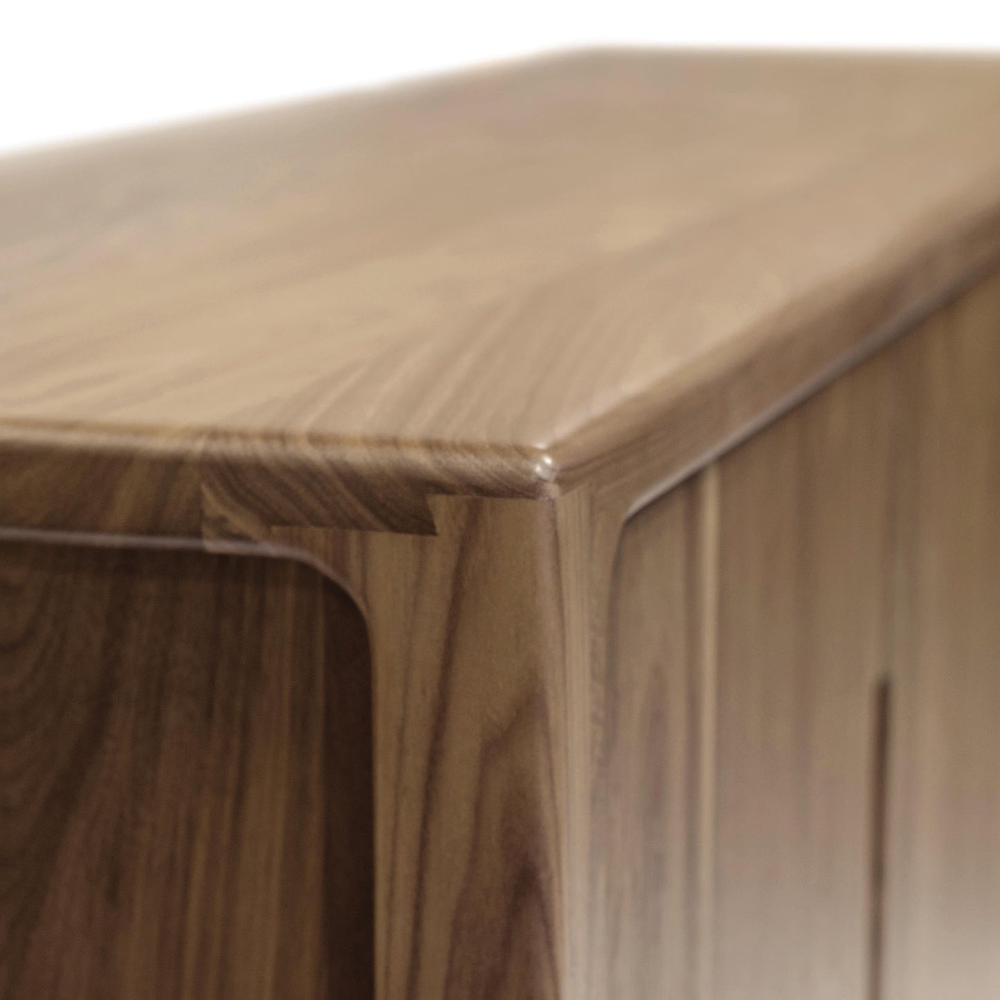 Copeland Furniture Lisse Buffet corner highlighting its smooth rounded edge and rich wood grain in a modern design.