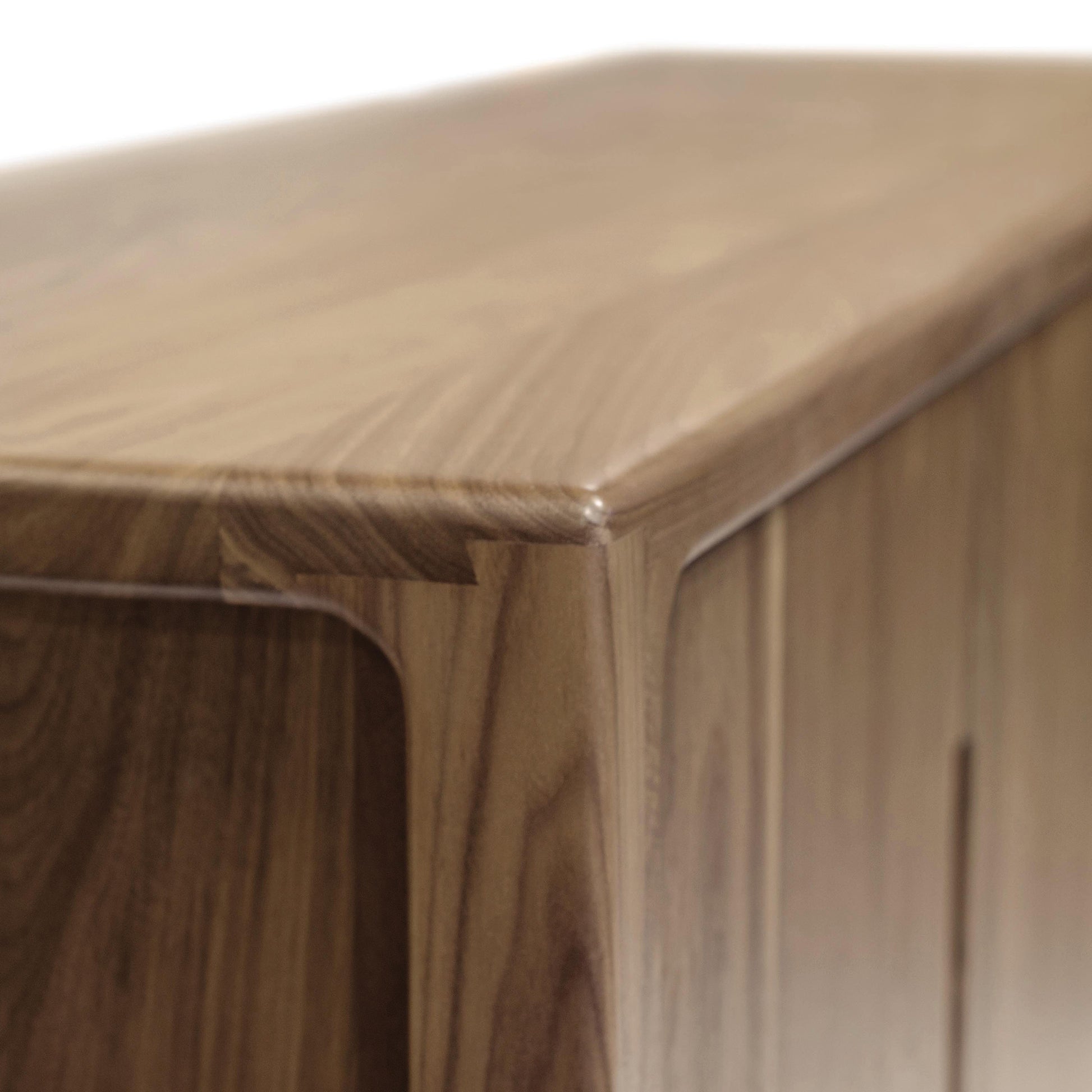 Copeland Furniture Lisse Buffet corner highlighting its smooth rounded edge and rich wood grain in a modern design.