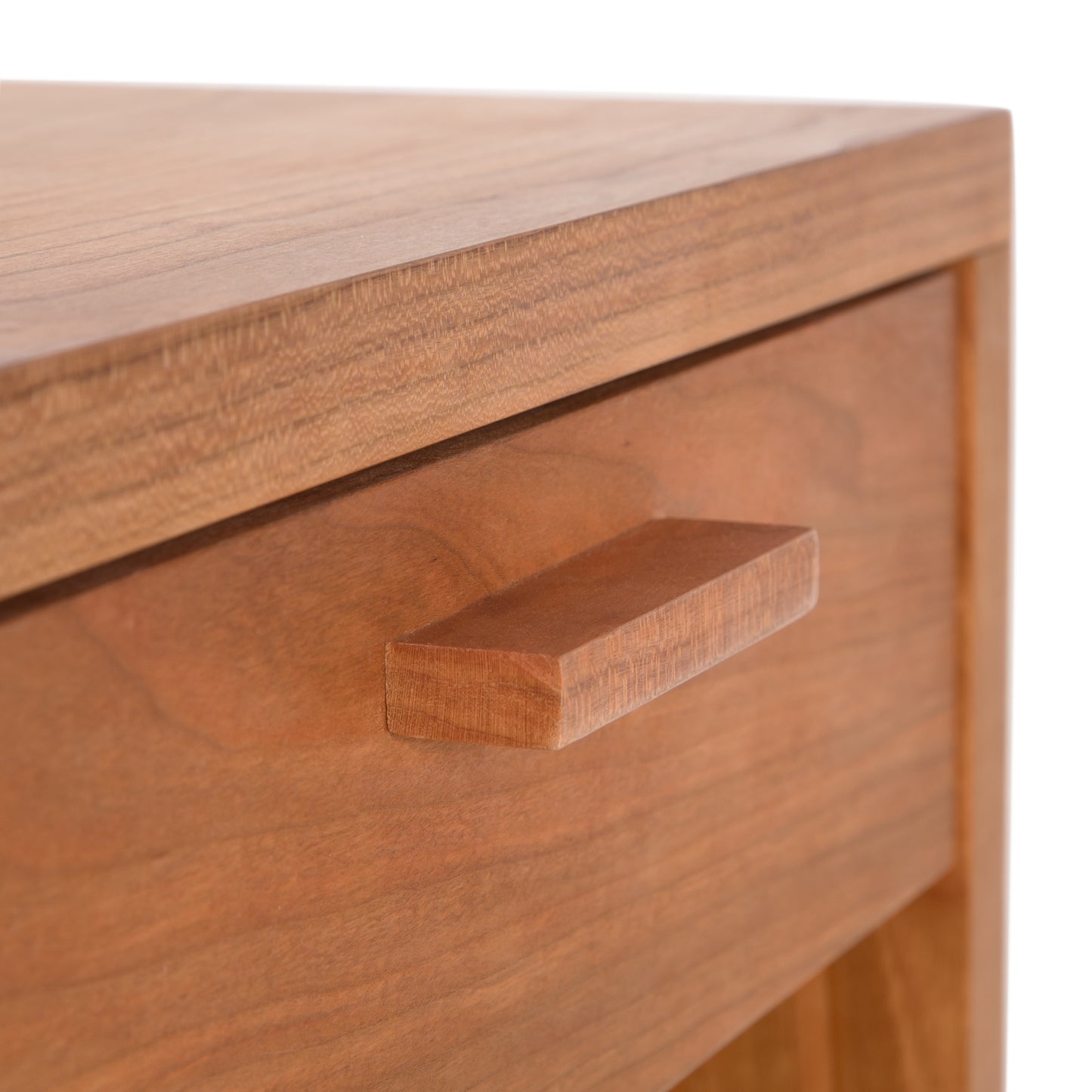 Close-up of a Vermont Furniture Designs Loft 1-Drawer Enclosed Shelf Nightstand drawer with a simple pull handle, highlighting the wood's natural grain.