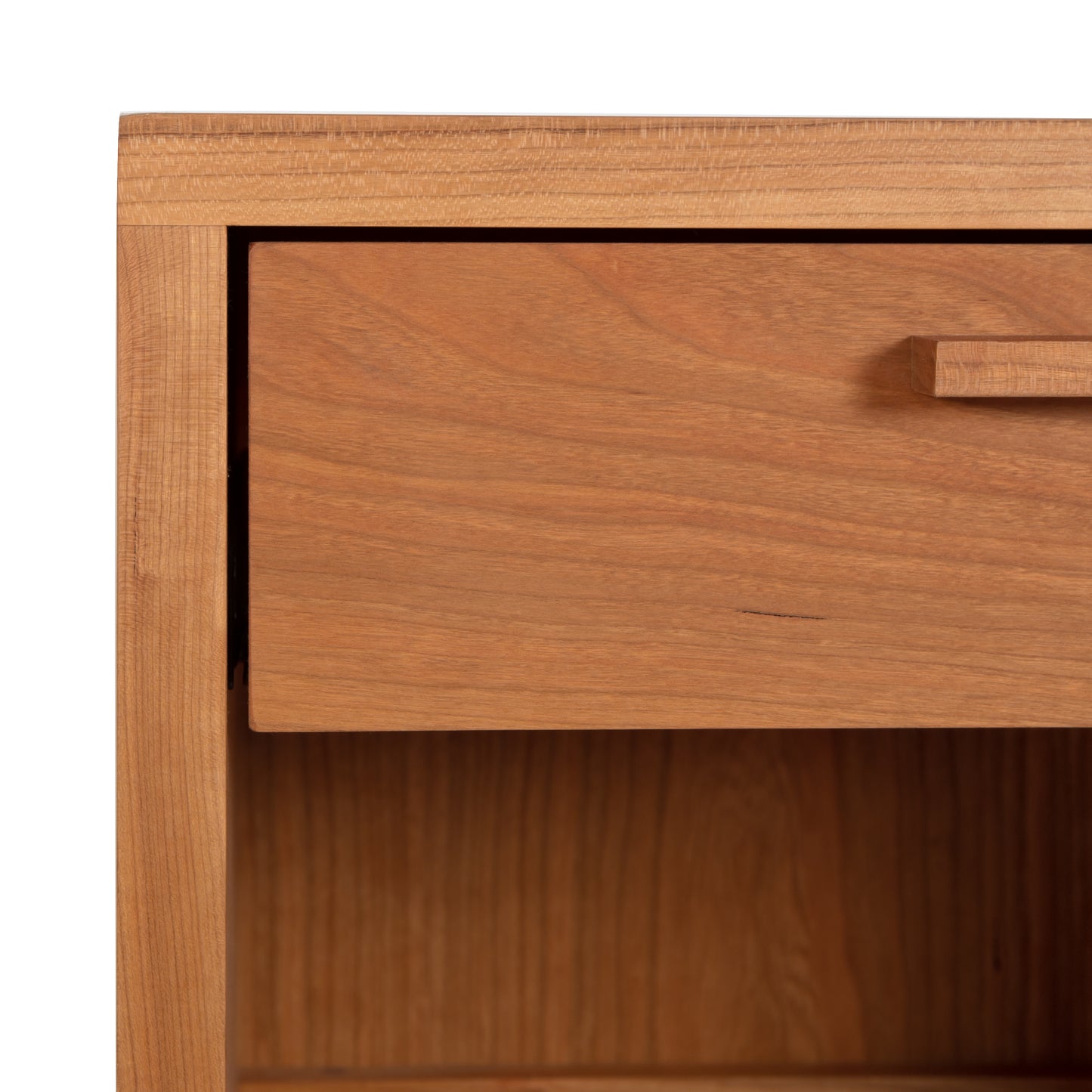A close-up of a Vermont Furniture Designs Loft 1-Drawer Enclosed Shelf Nightstand with a single drawer partially open, revealing its solid wood construction.