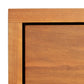 Close-up of a Vermont Furniture Designs Loft 5-Drawer Chest wooden frame corner on a white background.