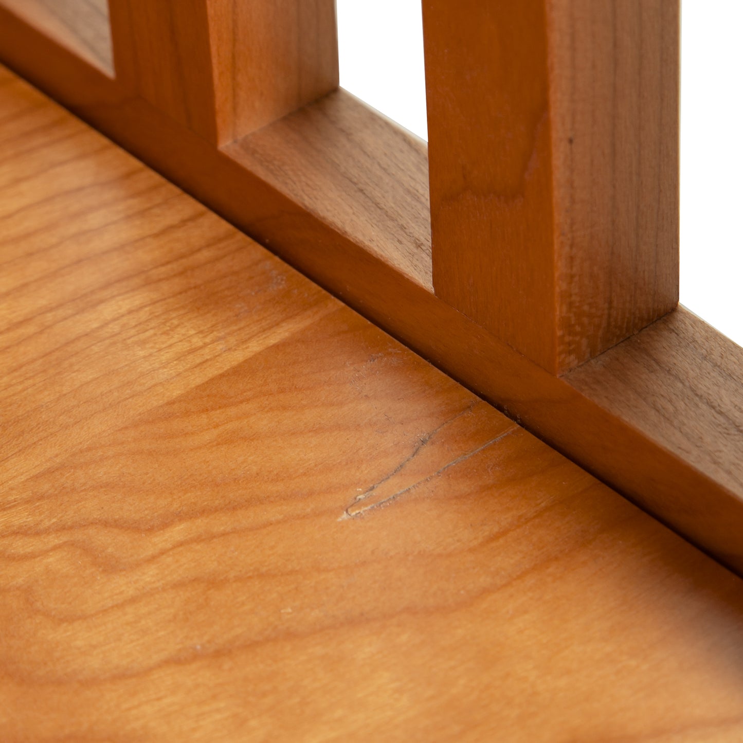 A close up of a Lyndon Furniture American Mission End Table with Shelf - Clearance, handmade wooden railing with a natural finish.