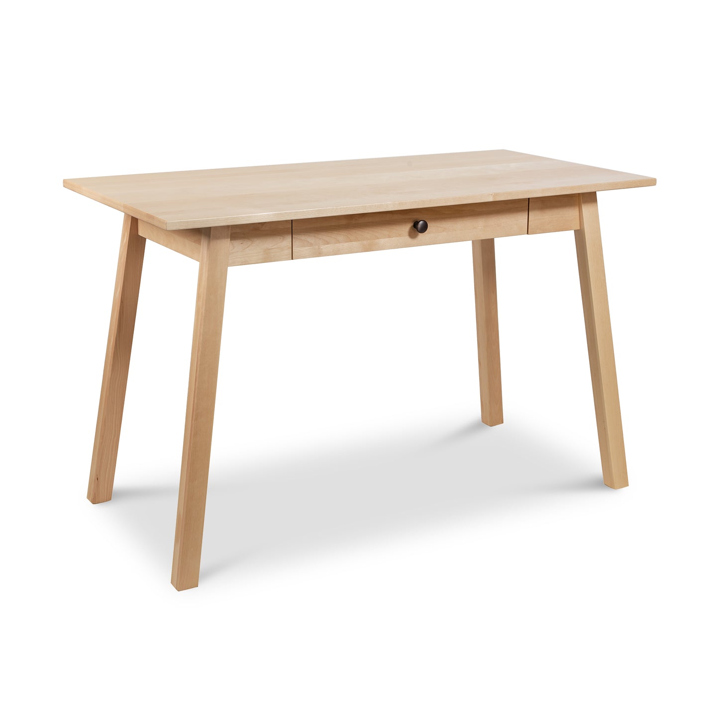 Manchester Writing Desk by Vermont Woods Studios - Sustainable Solid Wood, Light Natural Finish. Features four angled legs and a centered drawer with round metal pull. Perfect for modern home offices with minimalist design elements. Eco-friendly American-made furniture, ideal for those seeking solid wood desks and sustainable decor solutions.