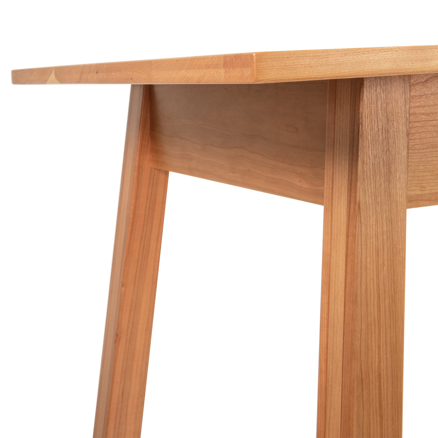 A close-up of the Vermont Woods Studios Manchester Writing Desk made from light-colored sustainable solid wood. This minimalist wooden desk showcases intricate craftsmanship and unique grain patterns, ideal for a modern home office. Perfect example of high-quality American made furniture including cherry wood, walnut wood, and maple furniture options.