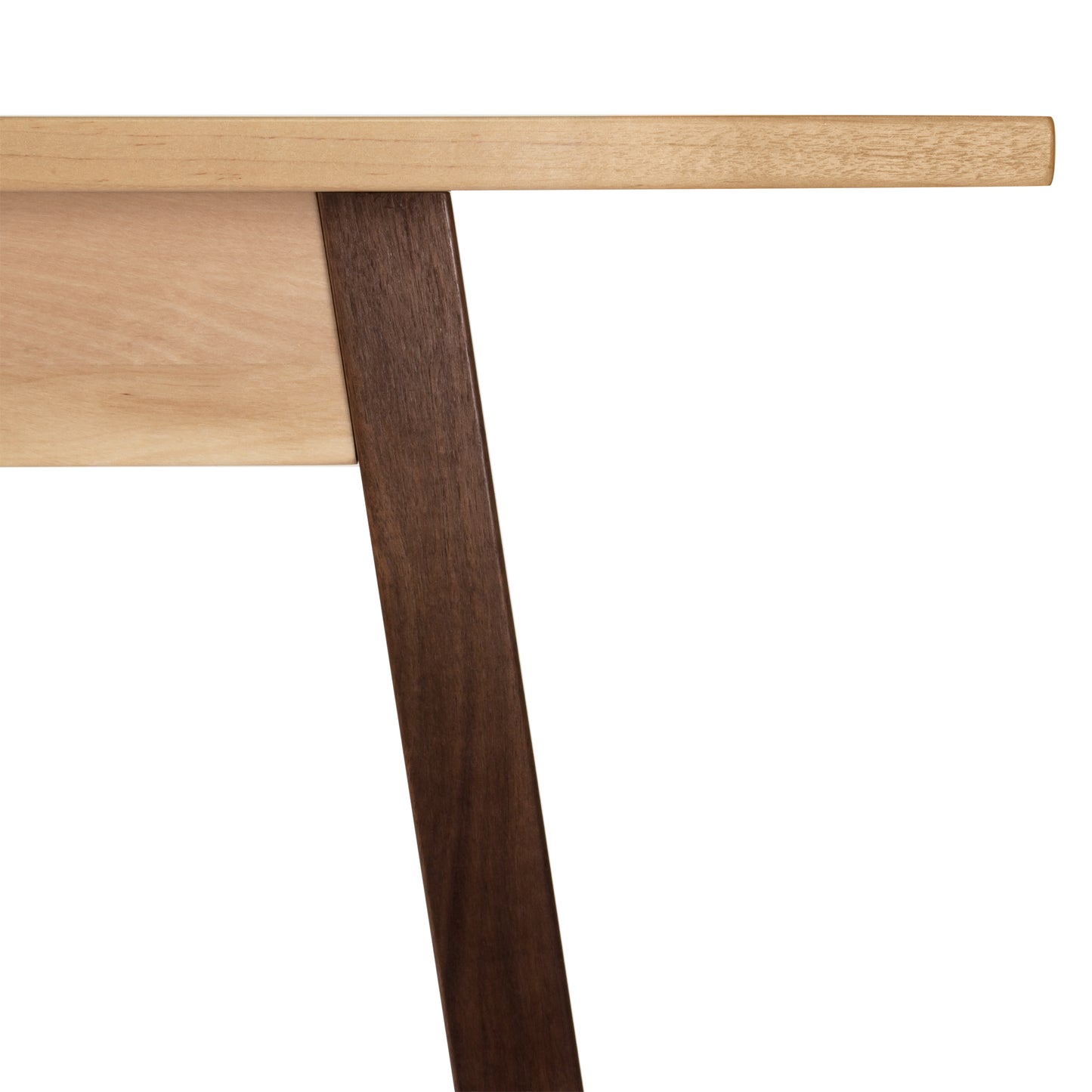 Close-up of Vermont Woods Studios Manchester Two-Tone Compact Desk highlighting light-colored tabletop and dark angled leg, showcasing modern solid wood furniture. Elegant design features American-made craftsmanship perfect for home office setups.
