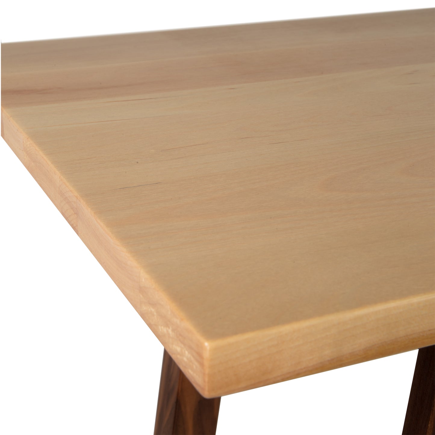 Close-up of Manchester Two-Tone Compact Desk corner by Vermont Woods Studios. Handcrafted solid wood furniture with light natural finish and smooth surface. Partial view of desk legs, ideal for modern American-made home office.