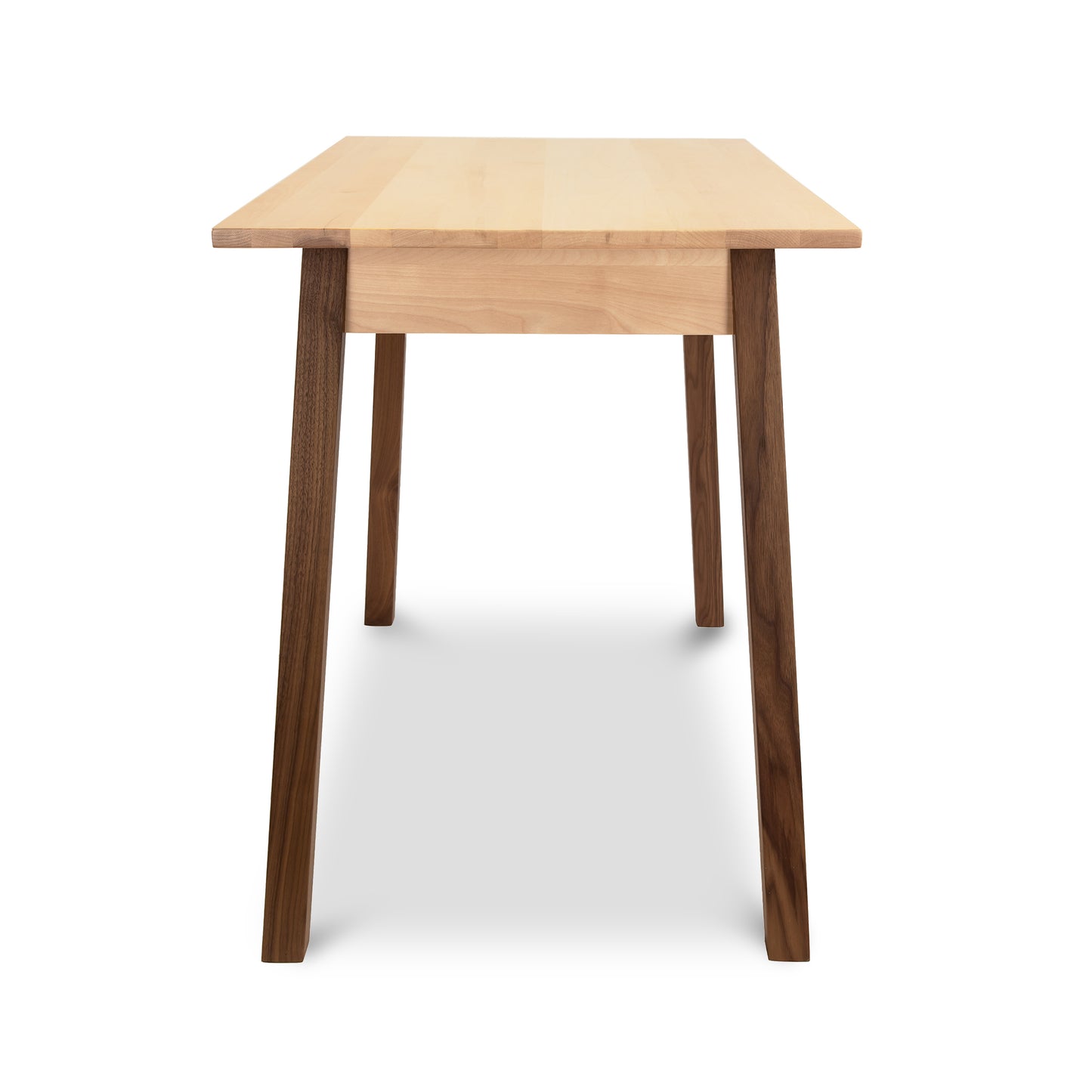 A Manchester Two-Tone Writing Desk from Vermont Woods Studios with a square light-colored tabletop and four dark tapered legs, isolated on a white background.