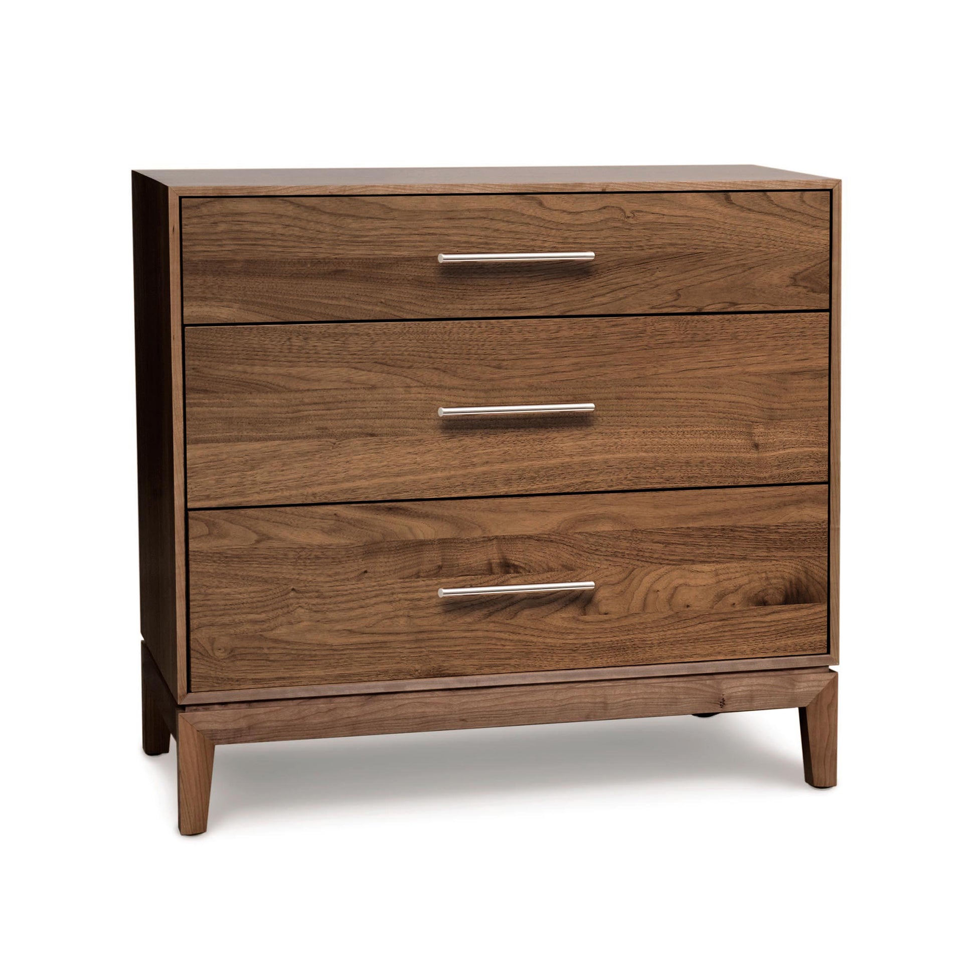 An Arts and Crafts style Mansfield 3-Drawer Chest by Copeland Furniture with metal handles on a white background.