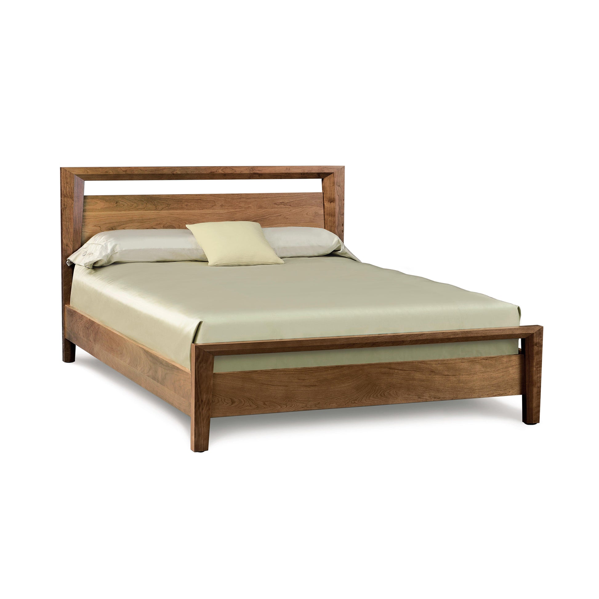 Solid wood Copeland Furniture Mansfield Platform Bed with clean Arts and Crafts lines, featuring a green bedspread and beige pillow.
