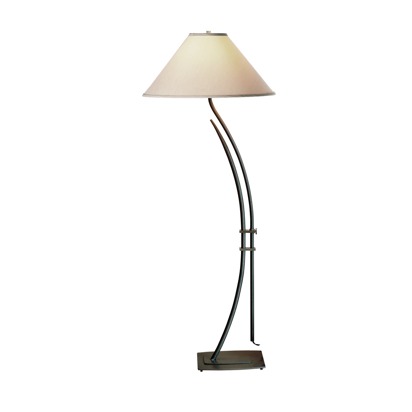 Hubbardton Forge Metamorphic floor lamp with beige conical shade and artisan-crafted metallic stand.