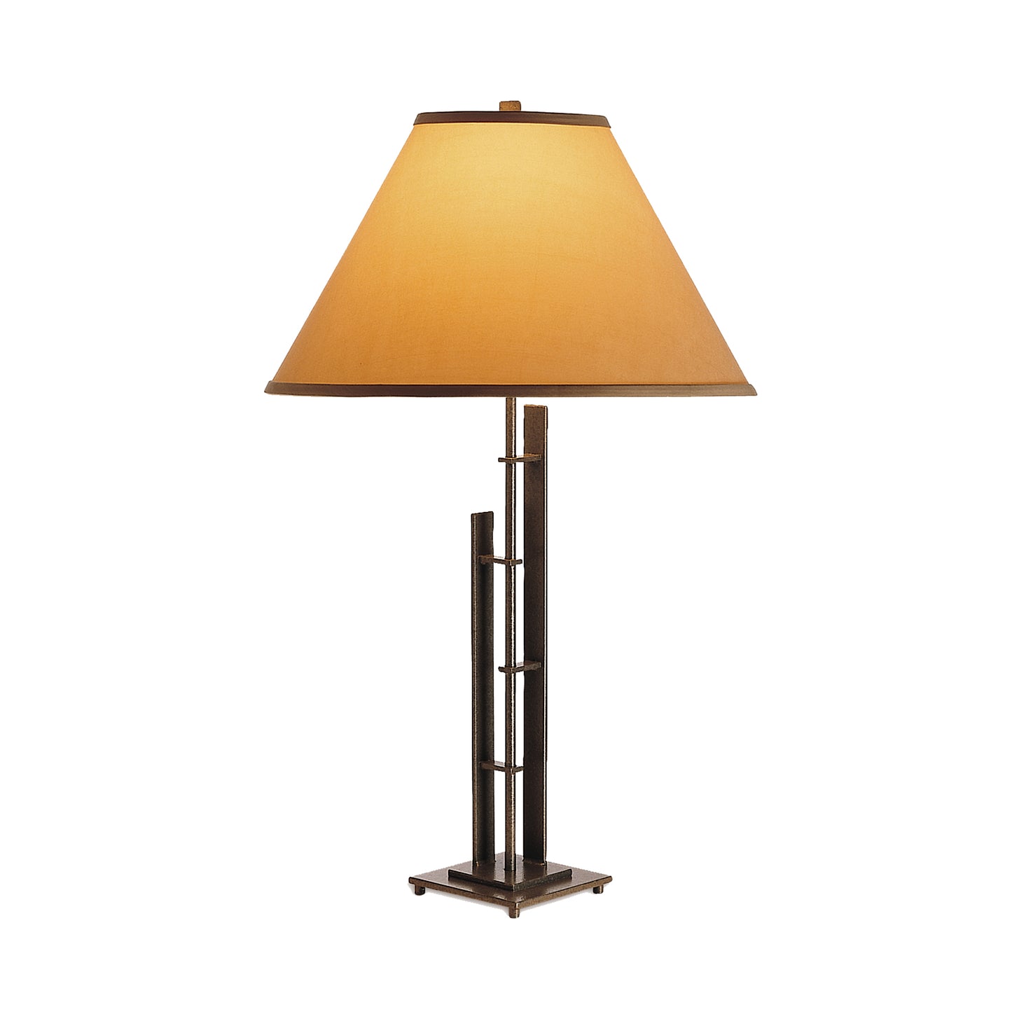 Metra Double #2 Table Lamp by Hubbardton Forge showcases a handcrafted beige conical shade atop a striking metallic geometric base, highlighting exquisite craftsmanship in American furniture design.