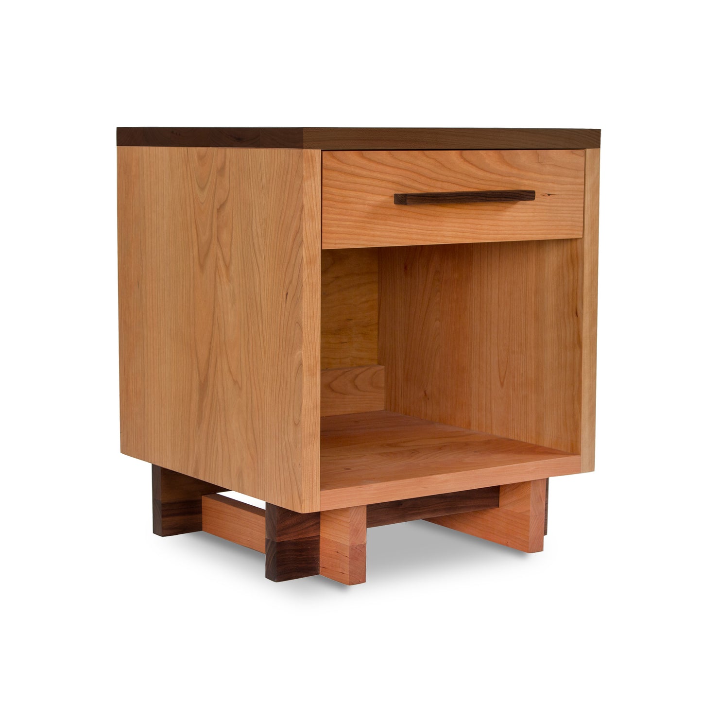 A Modern American 1-Drawer Enclosed Shelf Nightstand by Vermont Furniture Designs, featuring an open shelf and a single drawer, set against a white background. The stand has a simple, modern design with visible wood grain.