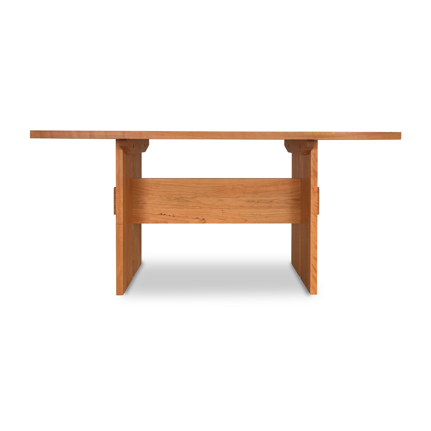 Modern American dining table in solid wood with natural cherry finish and sturdy legs.