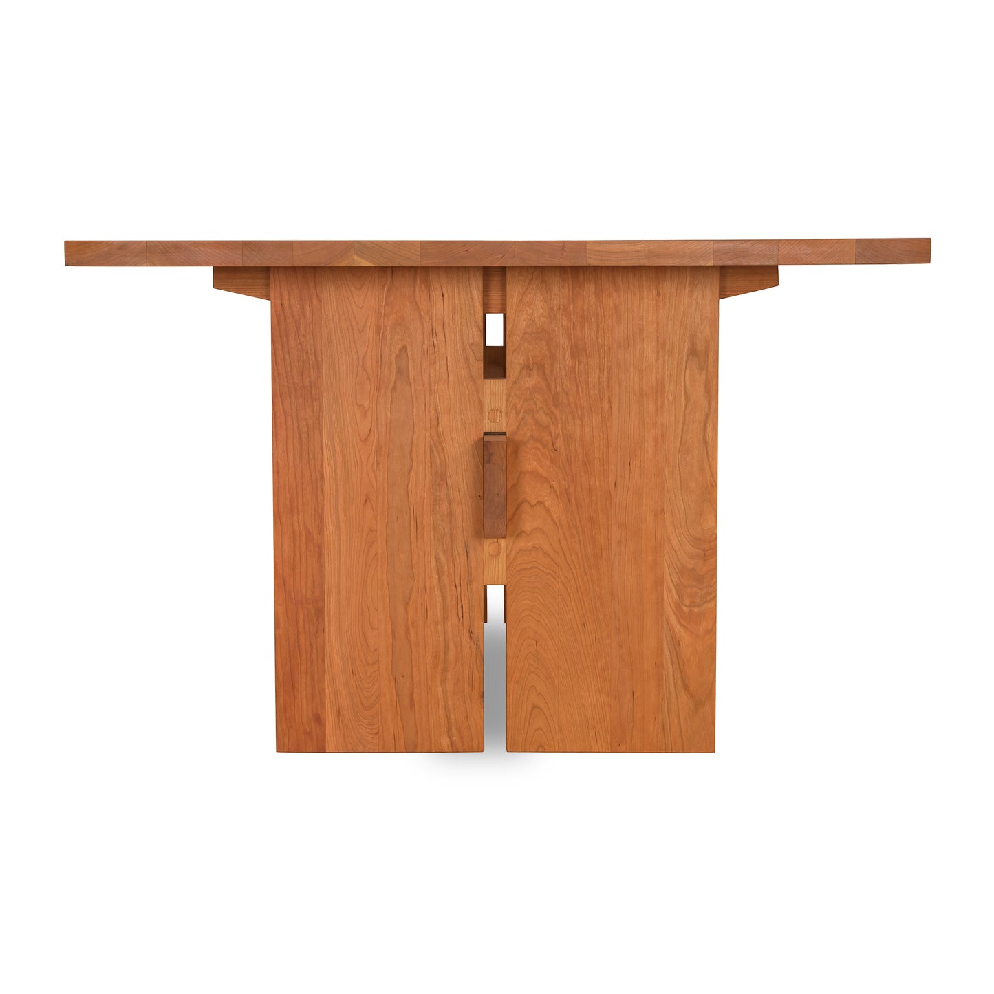 Solid cherry wood modern American dining table with a flat top and geometric base by Vermont Furniture Designs.