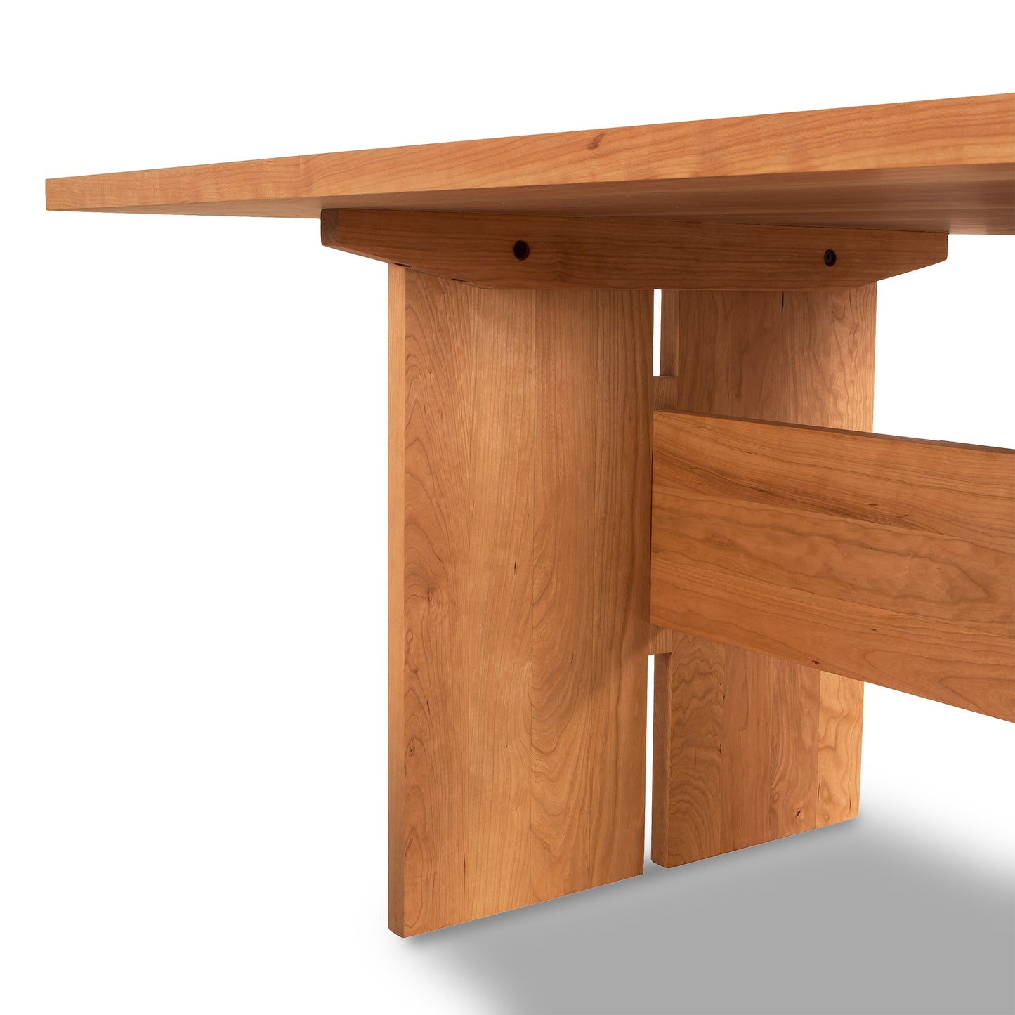 Modern American Dining Table by Vermont Furniture Designs featuring a rectangular top, thick legs, and solid wood construction showcasing natural grain patterns.