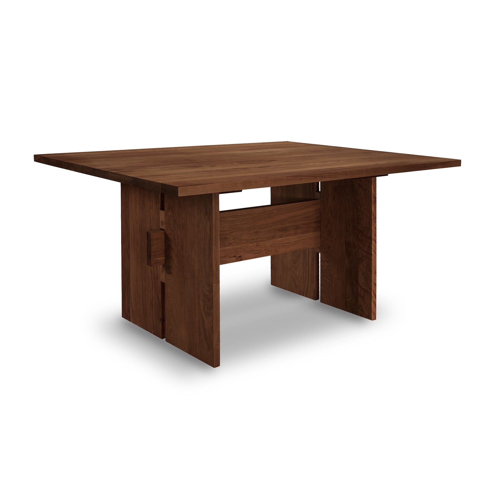 A Modern American Dining Table by Vermont Furniture Designs, with a solid wood construction and simple, sturdy design, isolated on a white background.