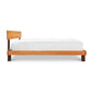 A single Vermont Furniture Designs Modern American Platform Bed with a wooden frame and white bedding isolated on a white background.