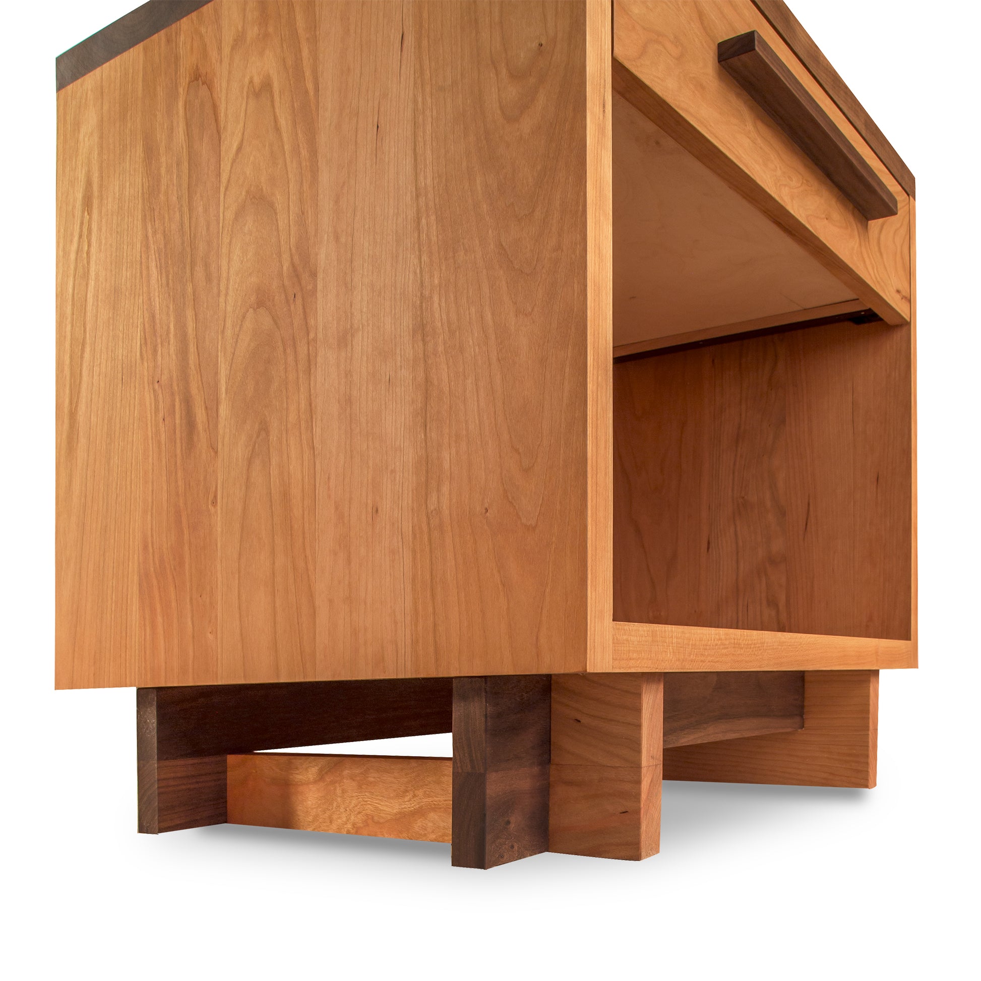 Close-up of a Modern American 1-Drawer Enclosed Shelf Wide Nightstand by Vermont Furniture Designs, with an open shelf, showing detailed grain texture and craftsmanship. The cabinet is elevated on short, solid legs and features a minimalist design.