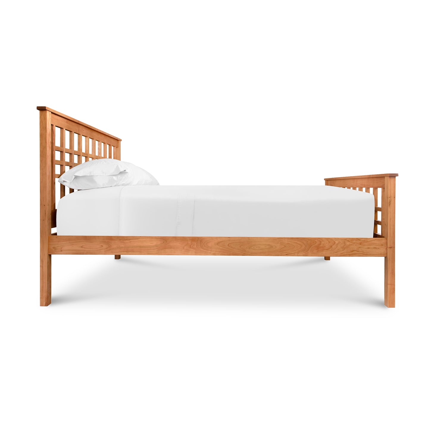 Handcrafted Modern Craftsman bed frame with grid design headboard and footboard by Vermont Furniture Designs, featuring a white mattress and pillows.