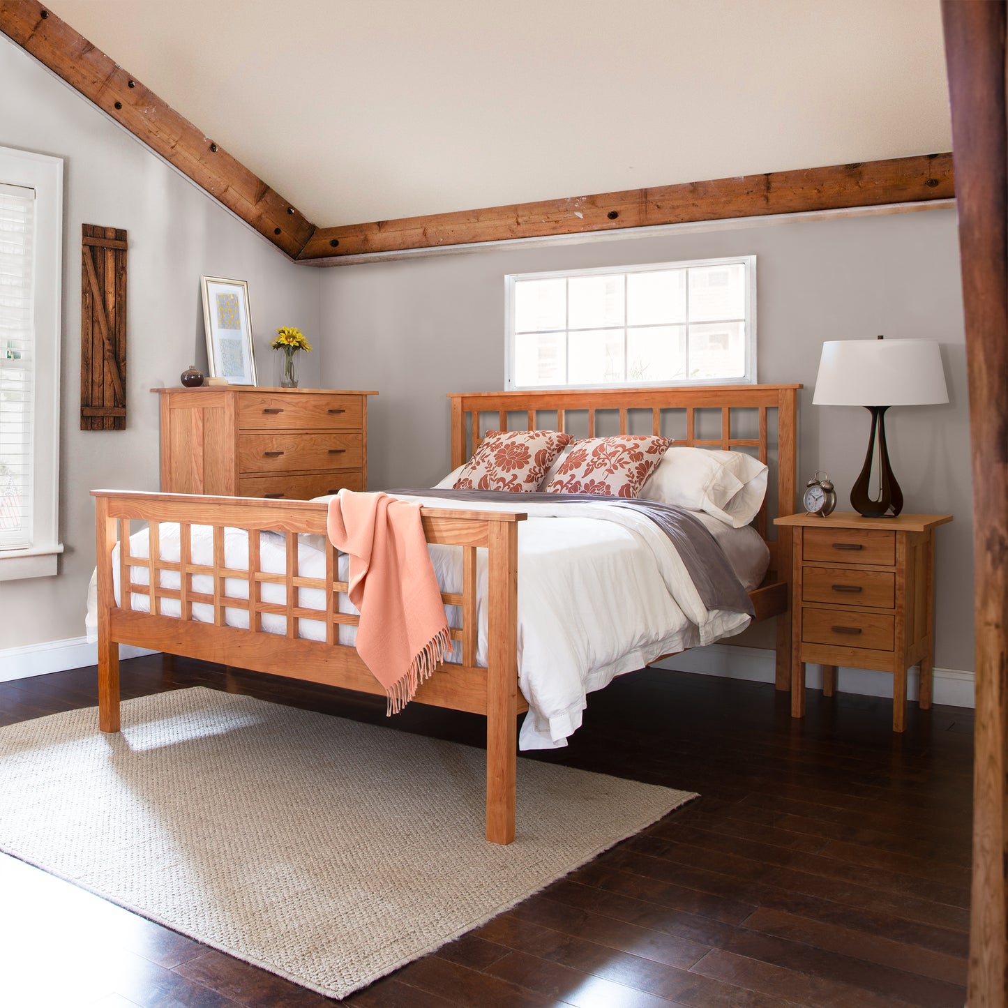 Vermont Furniture Designs Modern Craftsman High Footboard Bed with white bedding and orange throw, showcasing quality craftsmanship and elegant wood design.