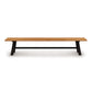 A Copeland Furniture modern farmhouse cherry bench with black metal legs on a white background.